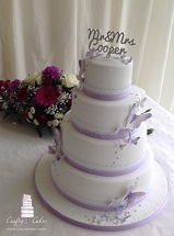 white & lilac 4 tier wedding cake with sugar butterflies